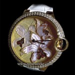 Orchid Granulation and engraved mother-of-pearl motif Ballon Bleu de Cartier 42mm watch. Introduced in 2015, this orchid granulation watch has an automatic movement and 22K yellow gold granulation on its 18K yellow gold dial. The 
orchid motif is in engraved mother-of-pearl and has 18K yellow gold flower petals covered in red enamel. Limited to 40 pieces. Photo: © TANG Portfolio. Elfa / Timmy. 2015 Salon International de la Haute Horlogerie.